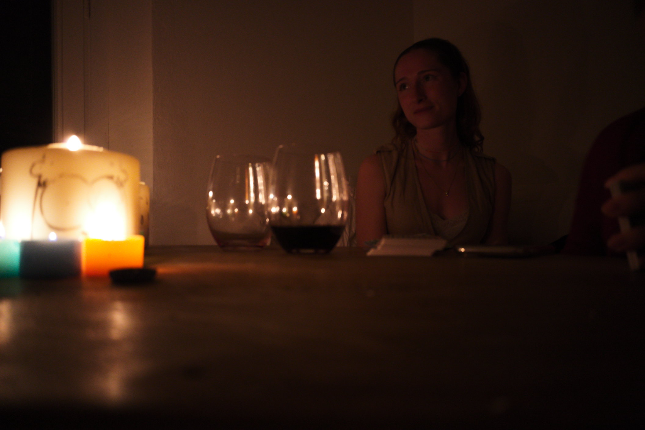 Candlelit dinner scene with Naomi in the background.